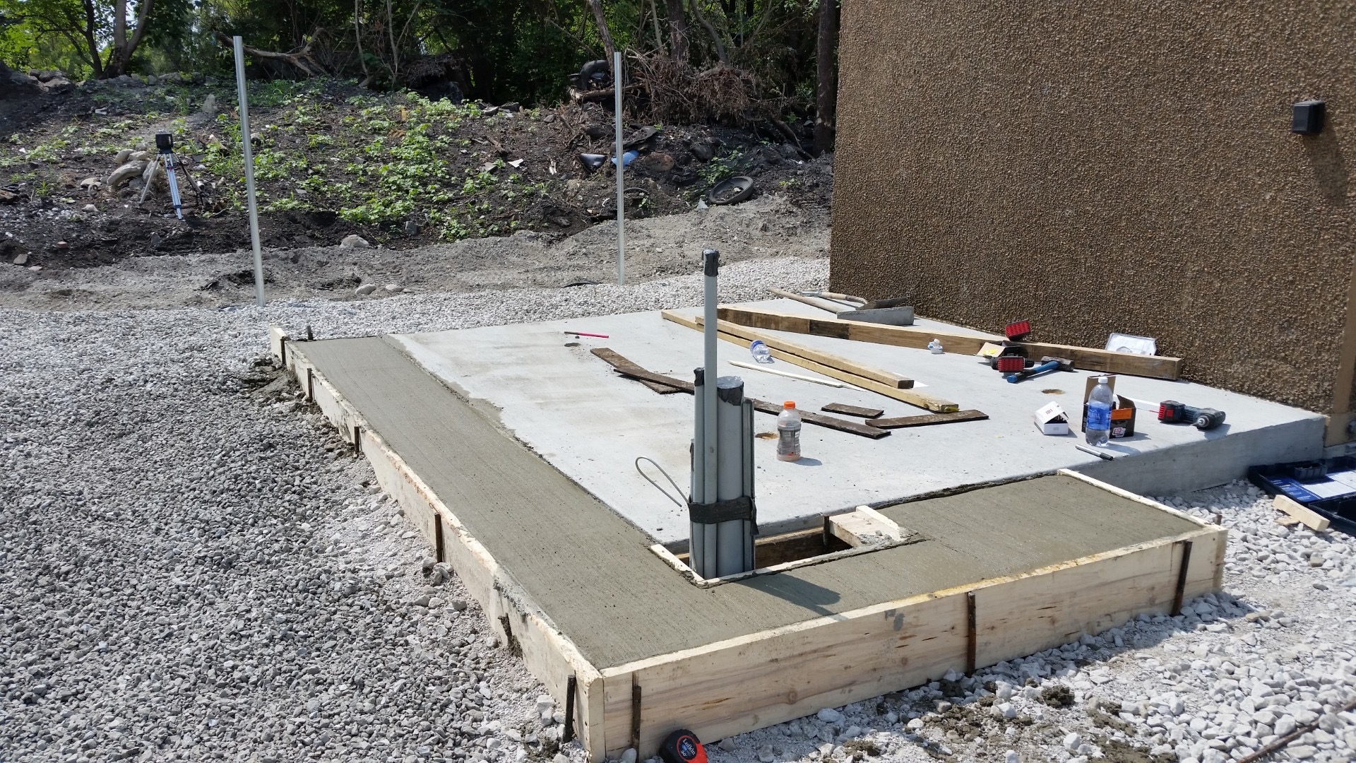 Finished concrete equipment pad with forms