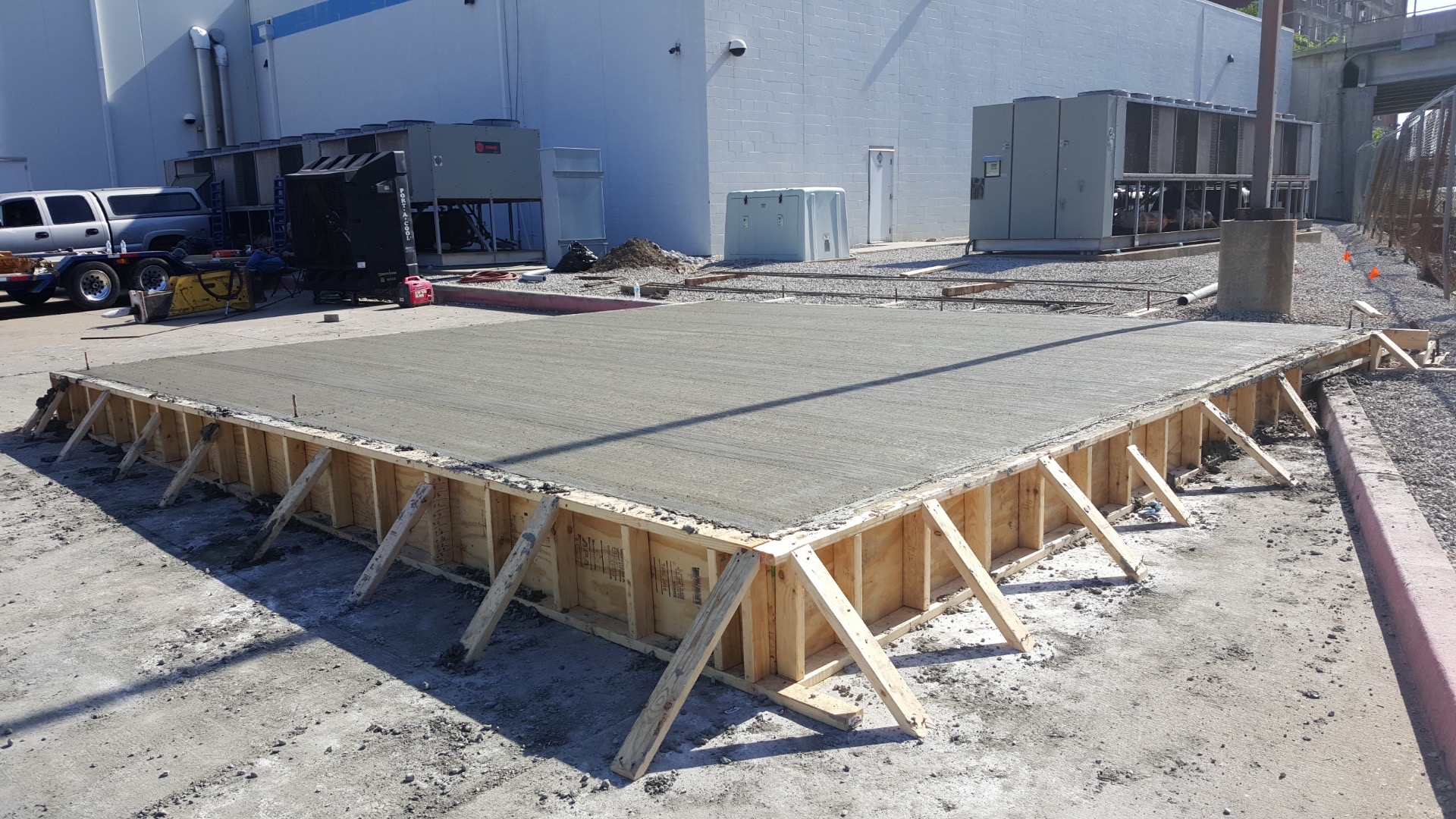 Large concrete pad pour with wood forms at commercial site