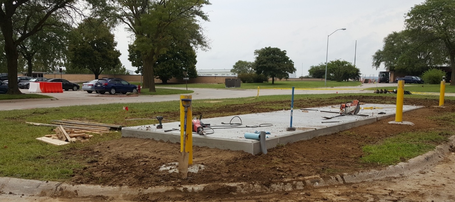 Concrete pad with bollards at completed site