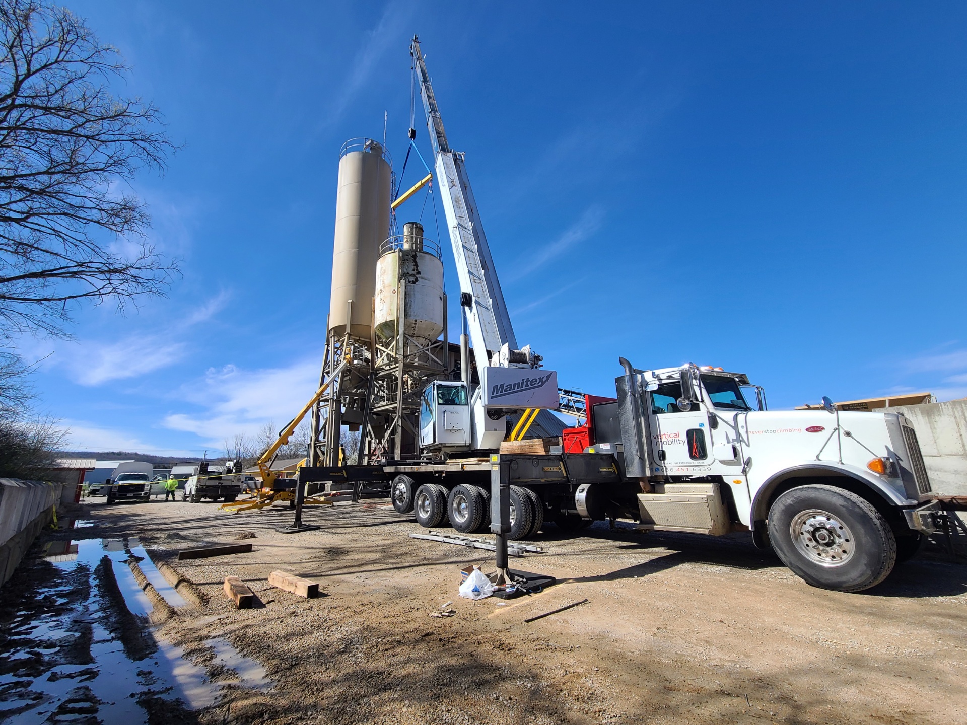 VMC boom truck performing lift at industrial site