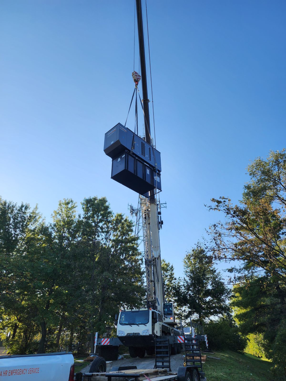 Crane lifting equipment shelter at tower site