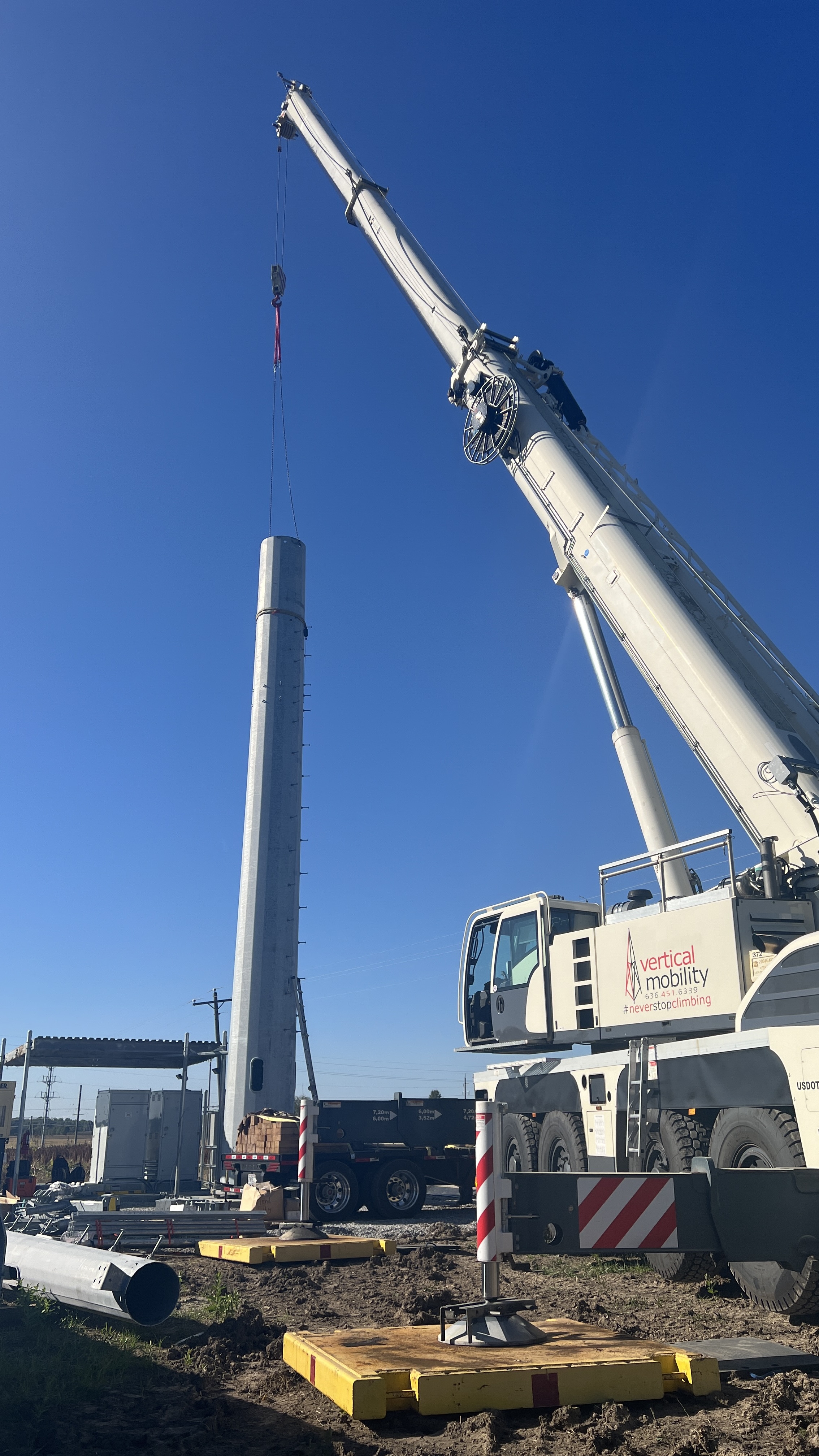 Crane lifting monopole section into place