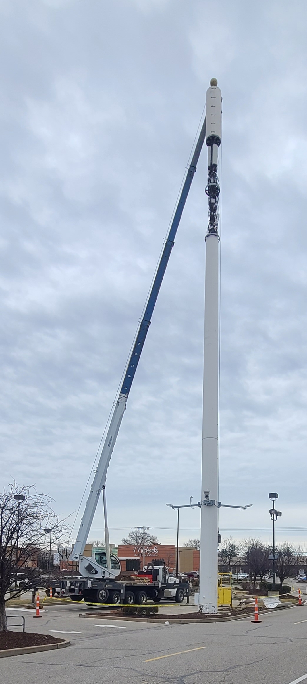 VMC crane performing work on telecom monopole tower