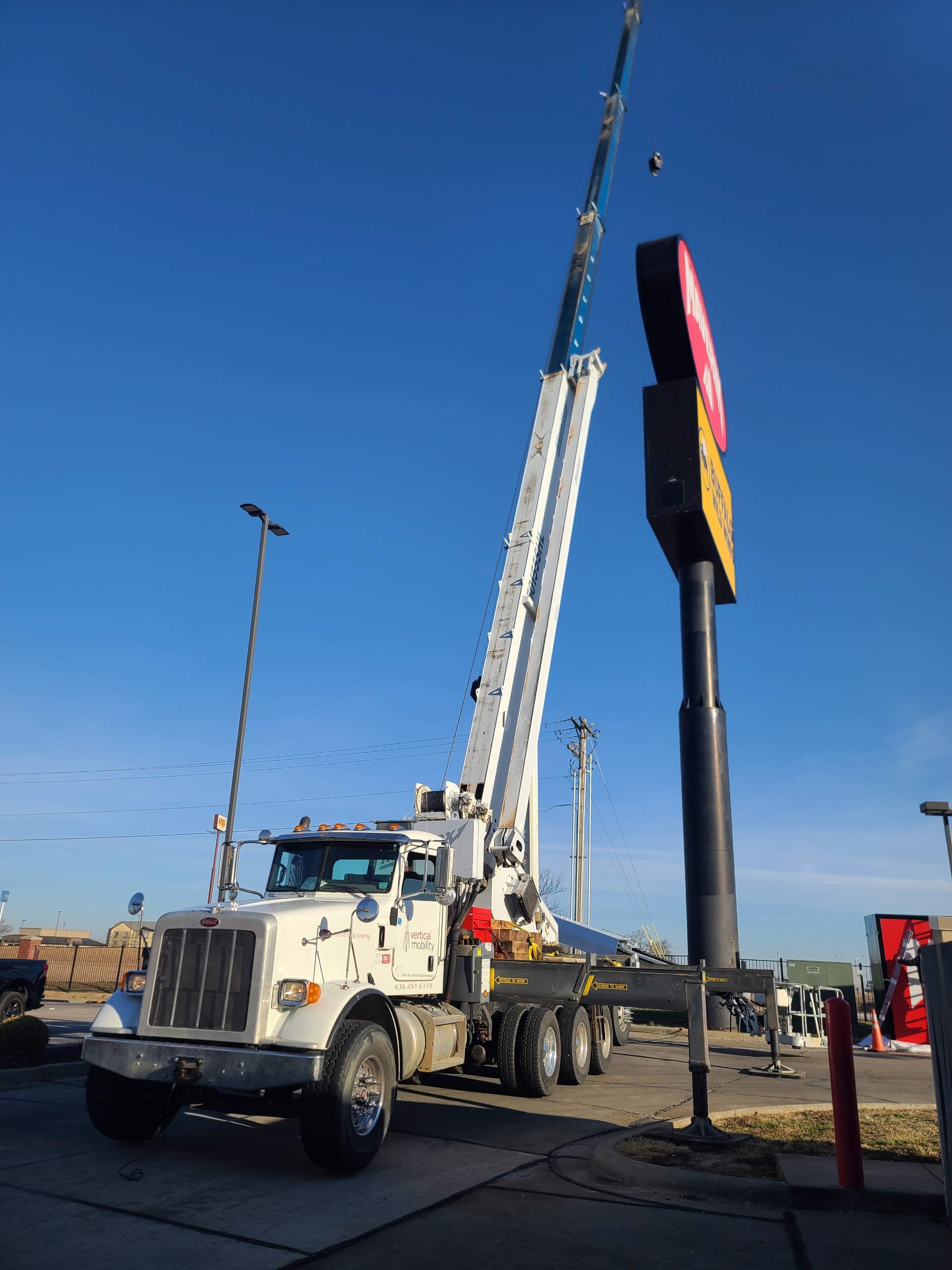 VMC boom truck lifting commercial sign